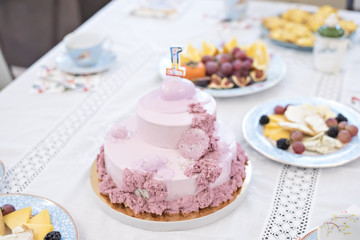 Festive tea drinking. The table is served with homemade cakes, cake, tea, fruits and flowers. Visiting grandmother.