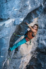 Blonde girl climbs tufa rock, Chitdibi, Turkey