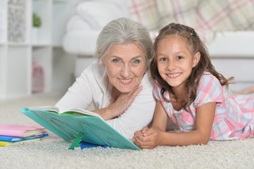 Grandmother with little girl doing homework