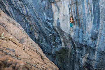 Blonde girl climbs tufa rock, Chitdibi, Turkey