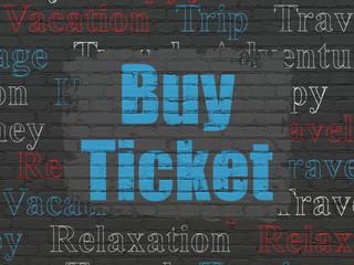 Vacation concept: Painted blue text Buy Ticket on Black Brick wall background with  Tag Cloud