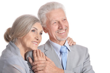 hugging senior couple on white background