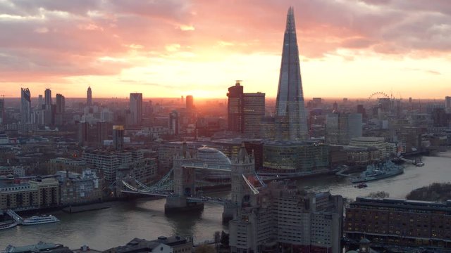 Breathtaking sunrise blazing over Tower Bridge, The Shard, and London cityscape