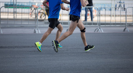 Fototapeta premium marathon runner legs running on city road