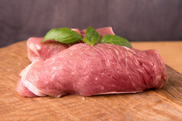 raw pork on a board made of mango tree