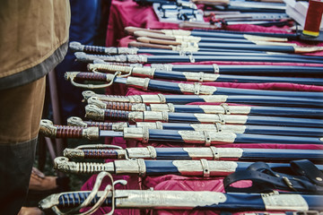 Selling cold arms of the Cossacks in the street. Sabers and Cossack checkers at the fair.