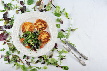 pancakes with potato salad in a bowl on a marble background