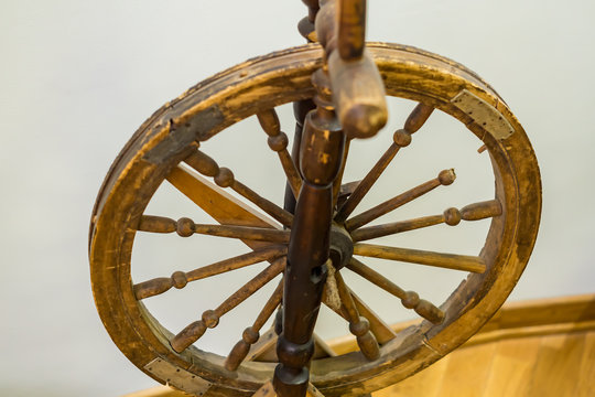 closeup of antique wooden spinning wheel