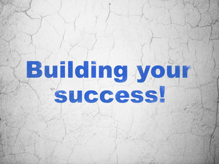 Business concept: Blue Building your Success! on textured concrete wall background