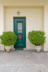 Fototapeta na wymiar Athens Greece, cosy house entrance with green door and plants