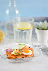 sandwich with salmon, cucumber, egg and onion
