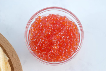 red caviar in a transparent glass bowl.