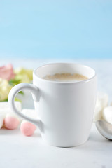 cappuccino inwhite mug with flowers and marshmallow