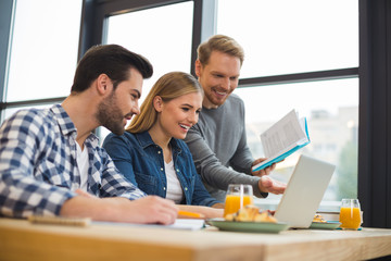 Cheerful joyful people discussing their startup