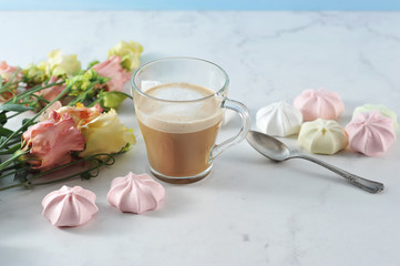cappuccino in transparent mug with flowers and marshmallow