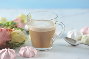 cappuccino in transparent mug with flowers and marshmallow