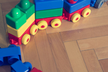 Closeup of colorful bricks on wooden floor.