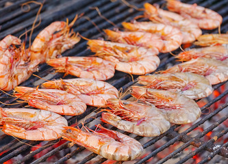 Prawn grilled barbecue seafood on charcoal stove. Thai street seafood.