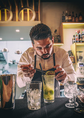 Bartender decorating cocktail