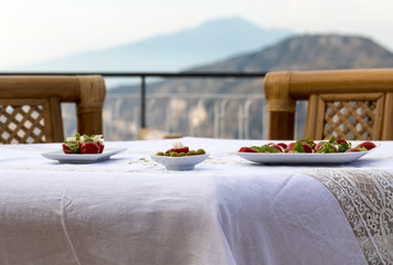 Prepared for supper table on the terrace overlooking the Bay of Naples and  Vesuvius. Sorrento. Italy