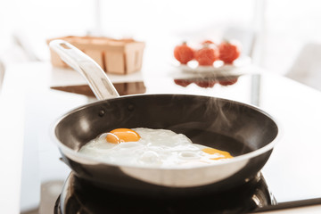 Cropped photo of delicious homemade scrambled eggs, cooked on frying pan