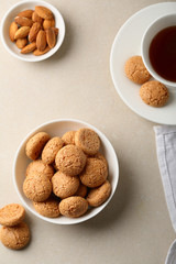 Almond cookies in white bowl and tea