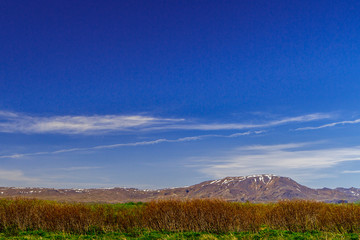 Naklejka premium Blue sky above the mountains and fields of Iceland
