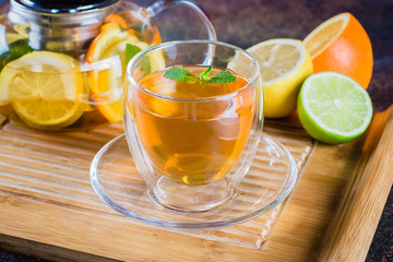 Cup of Citrus tea on wooden tray on blue stone table. Still life. Drink Healthcare Cold Concept.Selective focus, copy space