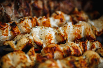 grilled chicken meat on the grill close up, barbecue, shashlik, kebab, skewer on the grill