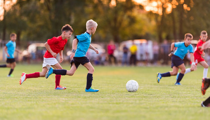 Fototapeta premium Young children players football match on soccer field