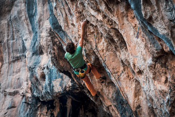 Men climbs a rock, 7c pitch with a rope, lead. Chitdibi, Turkey