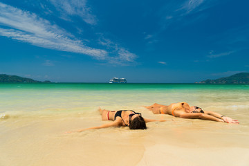 Fototapeta na wymiar Two women resting at the tropical Thailand Patong beach