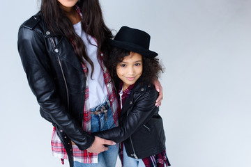 cropped shot of daughter embracing her mother isolated on grey