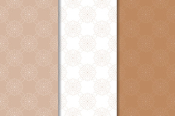 Set of floral ornaments. Brown, beige and white seamless patterns