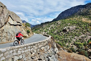 Corsica-cyclist on the way along the river Golo