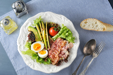 breakfast with bacon, avocado, egg and salad