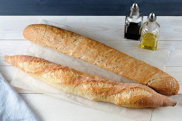 two baguette on Kraft paper on wooden background