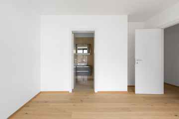 Empty room with attached marble bathroom