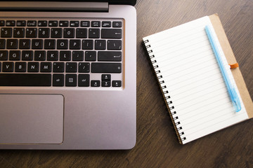 Keyboard of a laptop and a notebook with pen