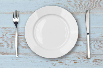 Light blue wood table with white plate setting top view