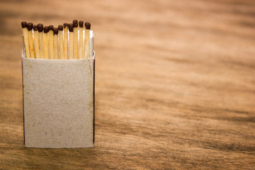 Matches in box, dark background. Close-up shot. Matches in box with a place for inscription