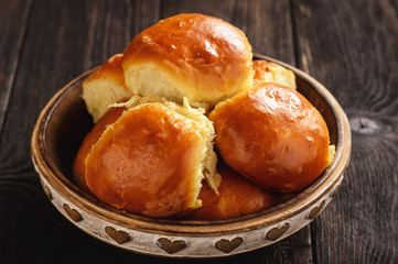 Homemade sweet bread rolls on dark background.