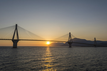 Fototapeta na wymiar Rio antirrio suspended bridge at sunset in Greece