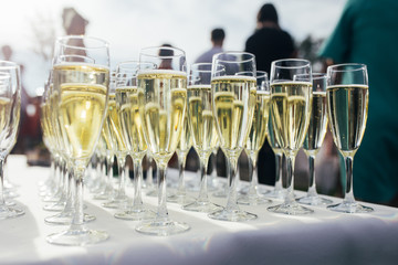 Many champagne glasses on a table in a wedding