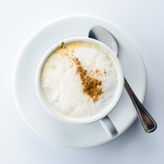 Cup of cappuccino coffee with chocolate. Top view, flat lay
