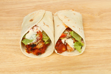 Two fajita wraps on a board