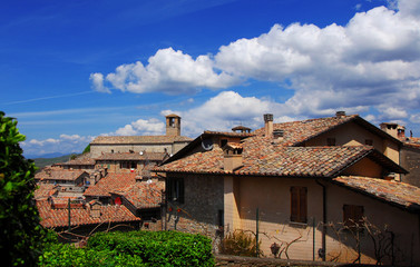 Fototapeta na wymiar View of the medieval historic center of Montone, a small town in the Umbria countryside in Italy, with old Saint Francis Church and clouds