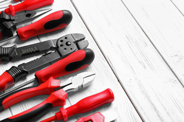 Different electrical tools on wooden background