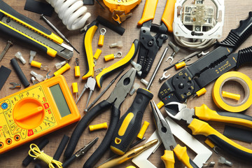 Different electrical tools on wooden background