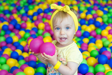 Fototapeta na wymiar Little girl playing in balloons